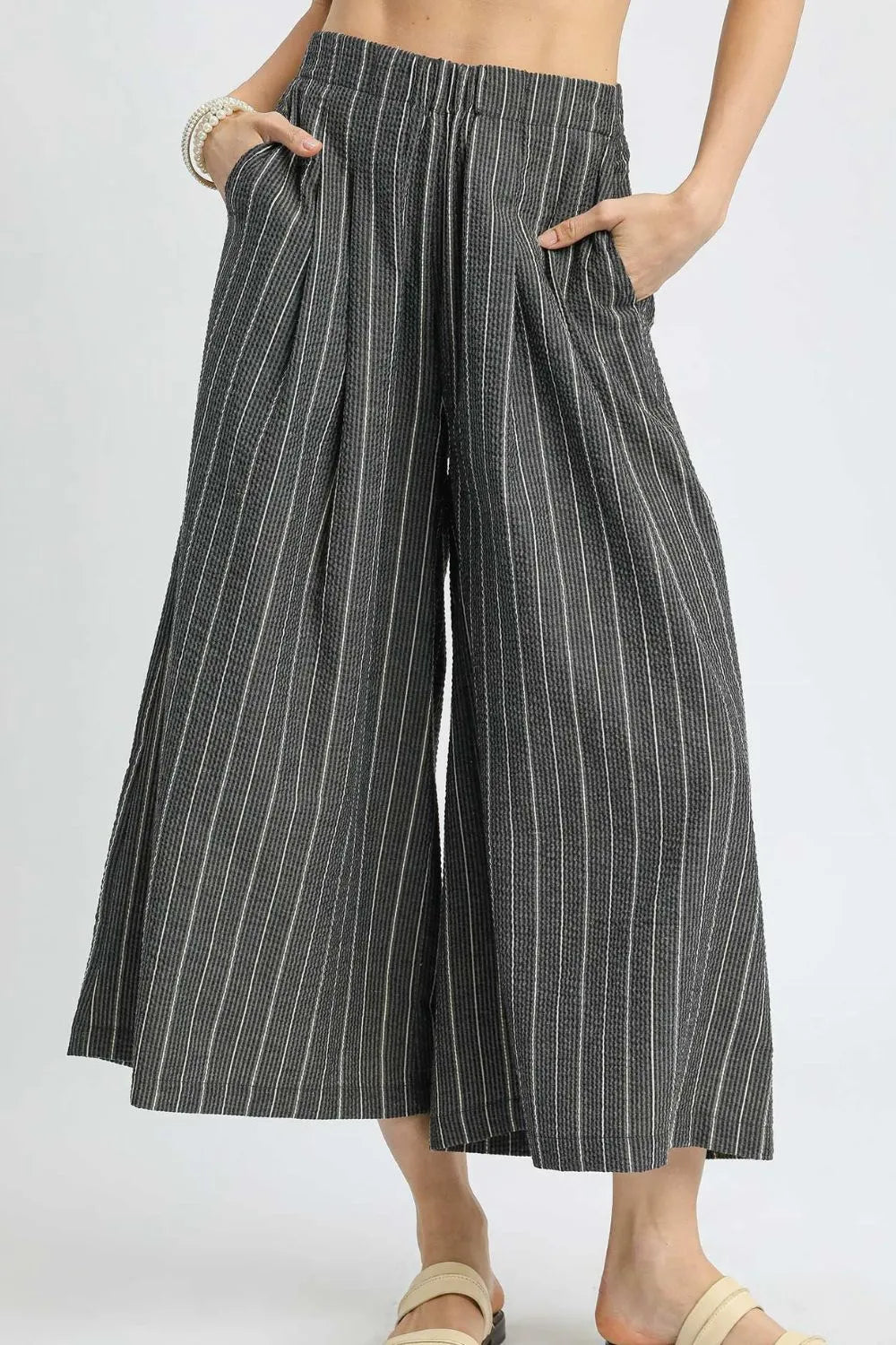 Black Umgee pinstripe crop palazzo pants with wide legs and high waist, shown on a model for trendy casual wear.