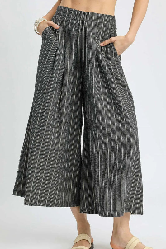 Black Umgee pinstripe crop palazzo pants with wide legs and high waist, shown on a model for trendy casual wear.