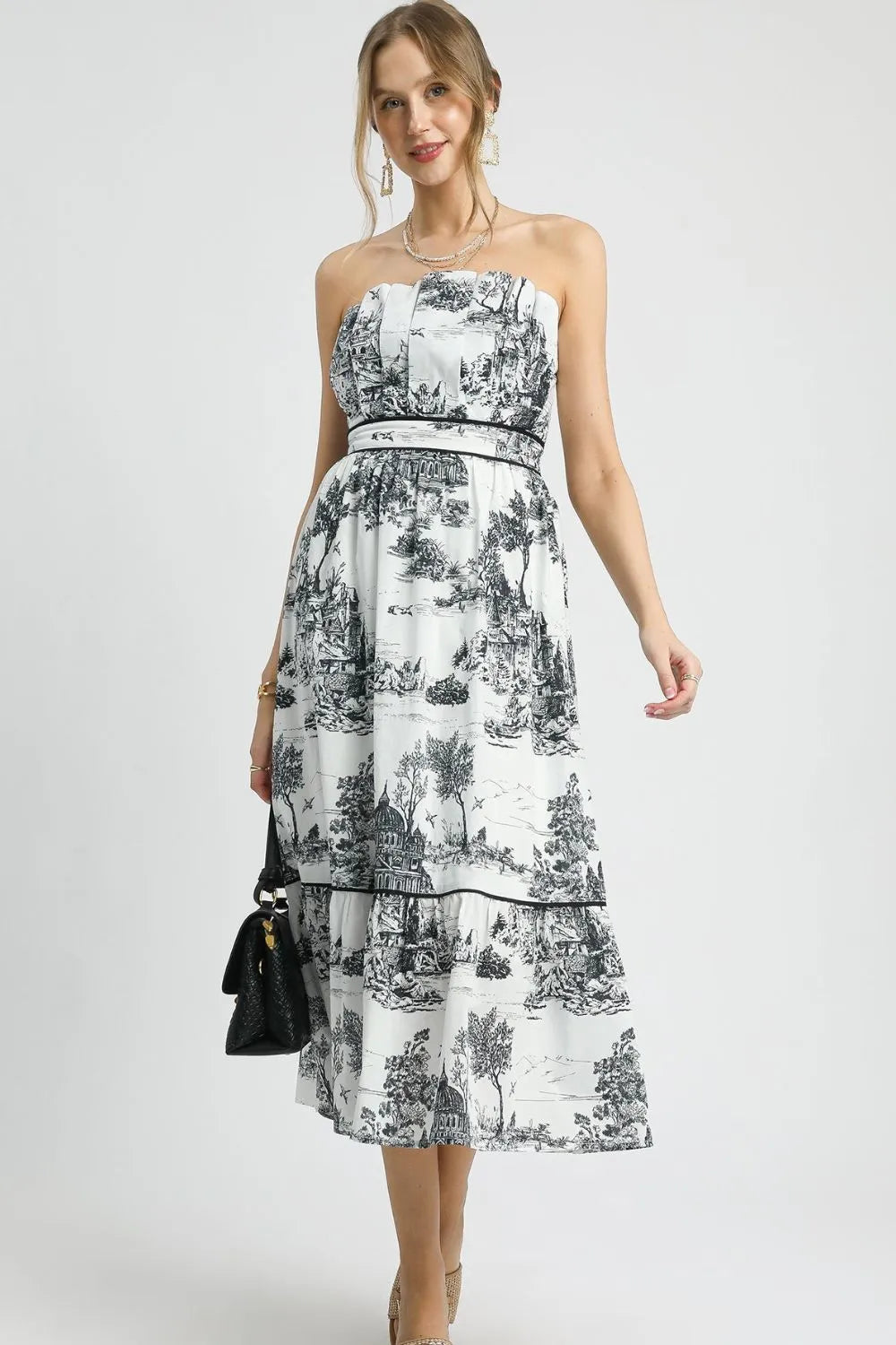 Black Umgee printed tiered tube midi dress with a fitted bodice and flowing skirt, perfect for casual or semi-formal occasions.