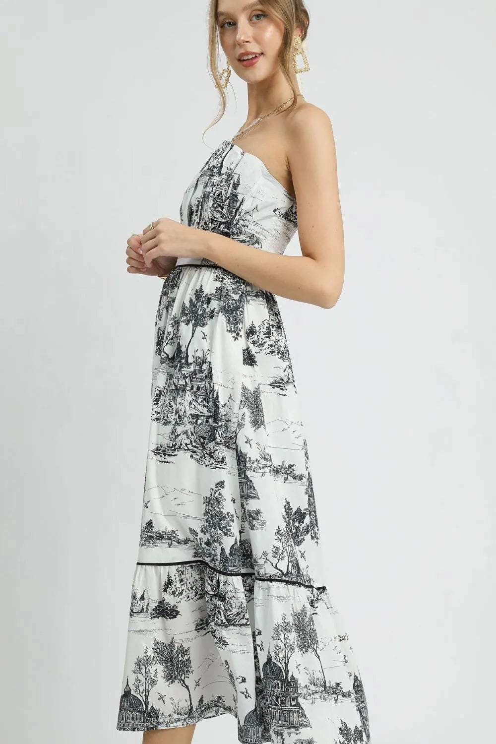 Black Umgee printed tiered tube midi dress with a fitted bodice and flowing, layered skirt, perfect for casual or semi-formal wear.