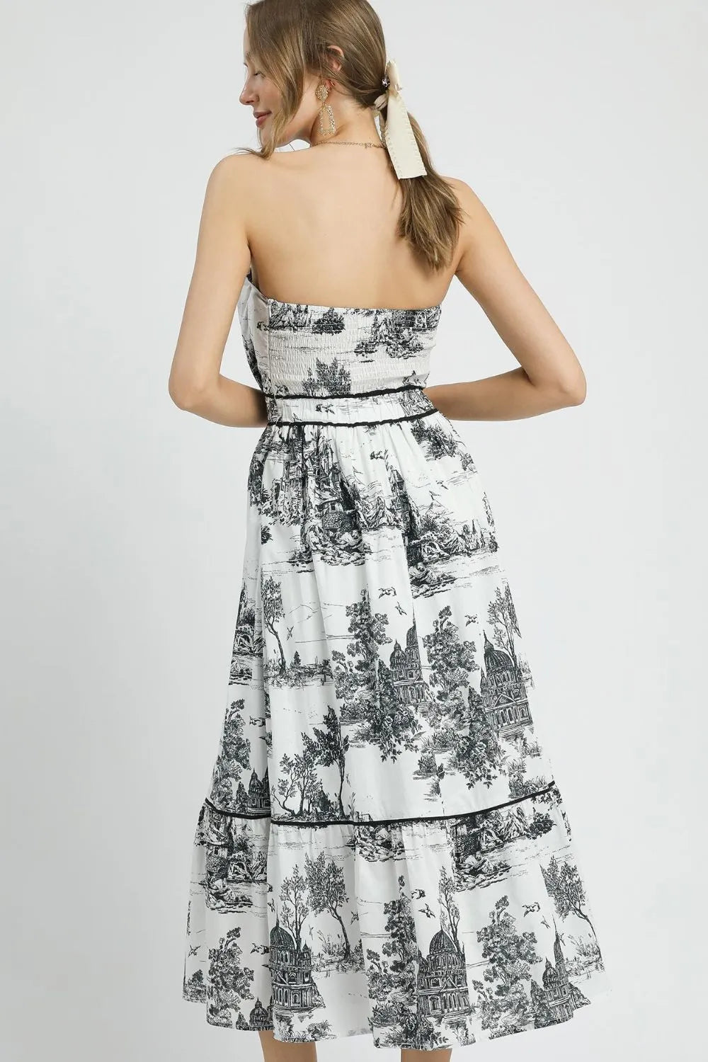 Black Umgee printed tiered tube midi dress with a sleeveless design, featuring a flowing, tiered skirt and vibrant pattern.