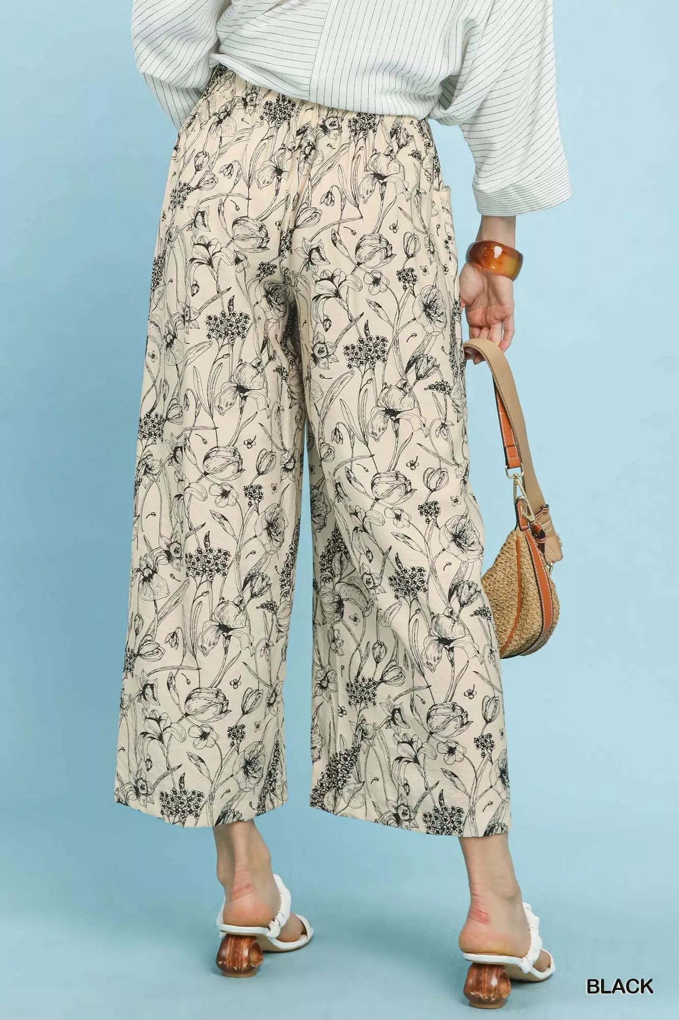 Black Umgee two-tone floral print pants with a relaxed fit, featuring a stylish and vibrant floral pattern, from Trendsi.