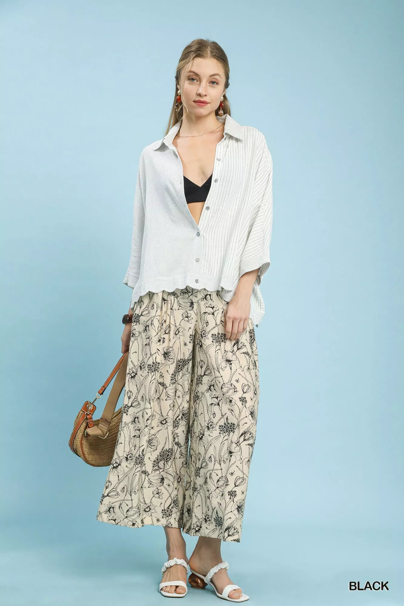 Black Umgee two-tone floral print pants with a relaxed fit and wide-leg design, featuring vibrant floral patterns.