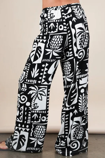 Black Very J printed casual wide-leg resort pants by Trendsi, featuring a relaxed fit and stylish pattern.