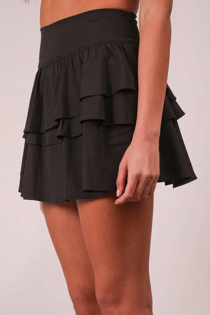 Black Very J Riffled Tiered Layers activewear skirt with built-in shorts, designed for comfort and style during workouts.
