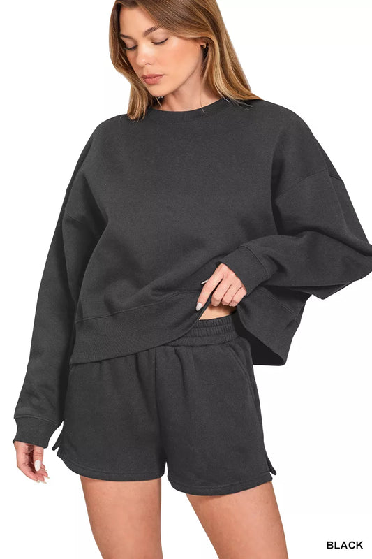 Black Zenana fleece sweatshirt and shorts set by Trendsi, featuring a round neck, cozy fabric, and casual loungewear style.