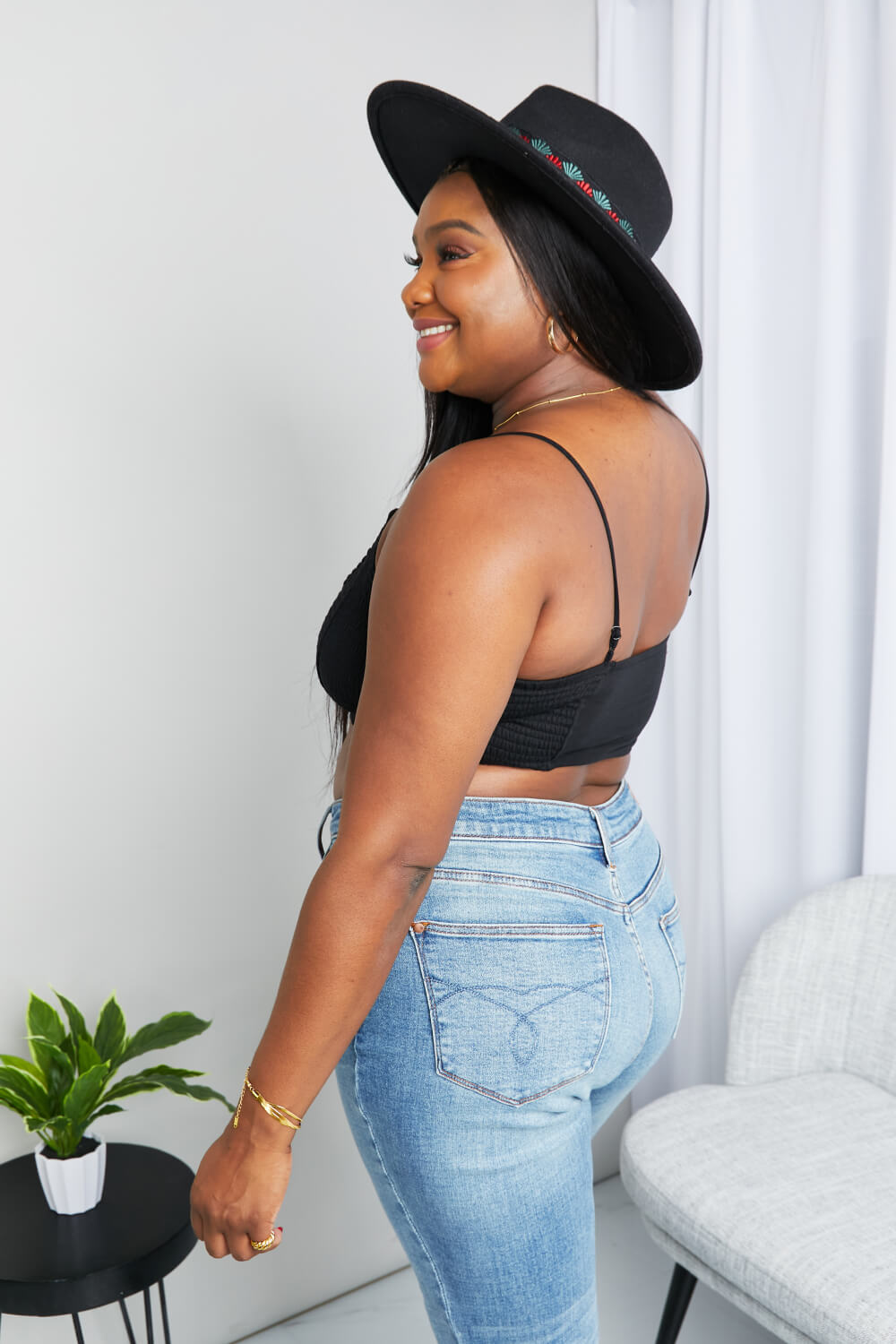 Black Zenana full-size textured spaghetti strap bralette with soft fabric and adjustable straps, shown on a model.