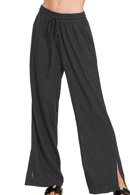 Black Zenana linen drawstring pants by Trendsi, featuring a relaxed fit with an adjustable waistband and lightweight fabric.