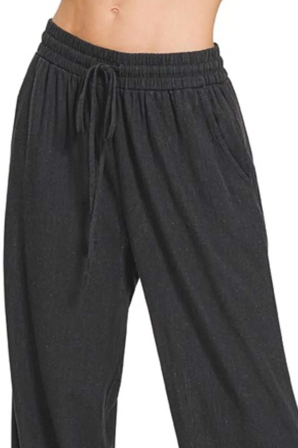 Black Zenana Linen Drawstring Pants by Trendsi, showing relaxed fit with adjustable drawstring waist and lightweight linen fabric.