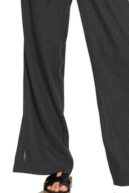 Black Zenana linen drawstring pants with relaxed fit and adjustable waist tied with a drawstring.