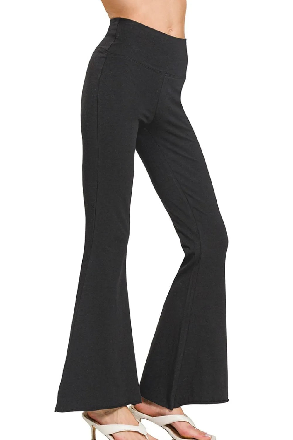 Black Zenana Raw Edge Hem Flare Yoga Pants by Trendsi, featuring a relaxed fit with raw-edged hem and flare design.