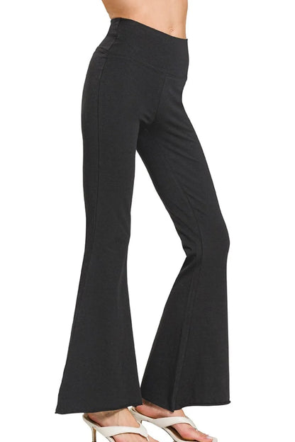 Black Zenana Raw Edge Hem Flare Yoga Pants by Trendsi, featuring a relaxed fit with raw-edged hem and flare design.