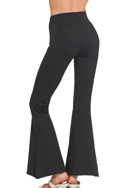 Black Zenana Raw Edge Hem Flare Yoga Pants by Trendsi, featuring a relaxed fit and stylish raw hem detail.
