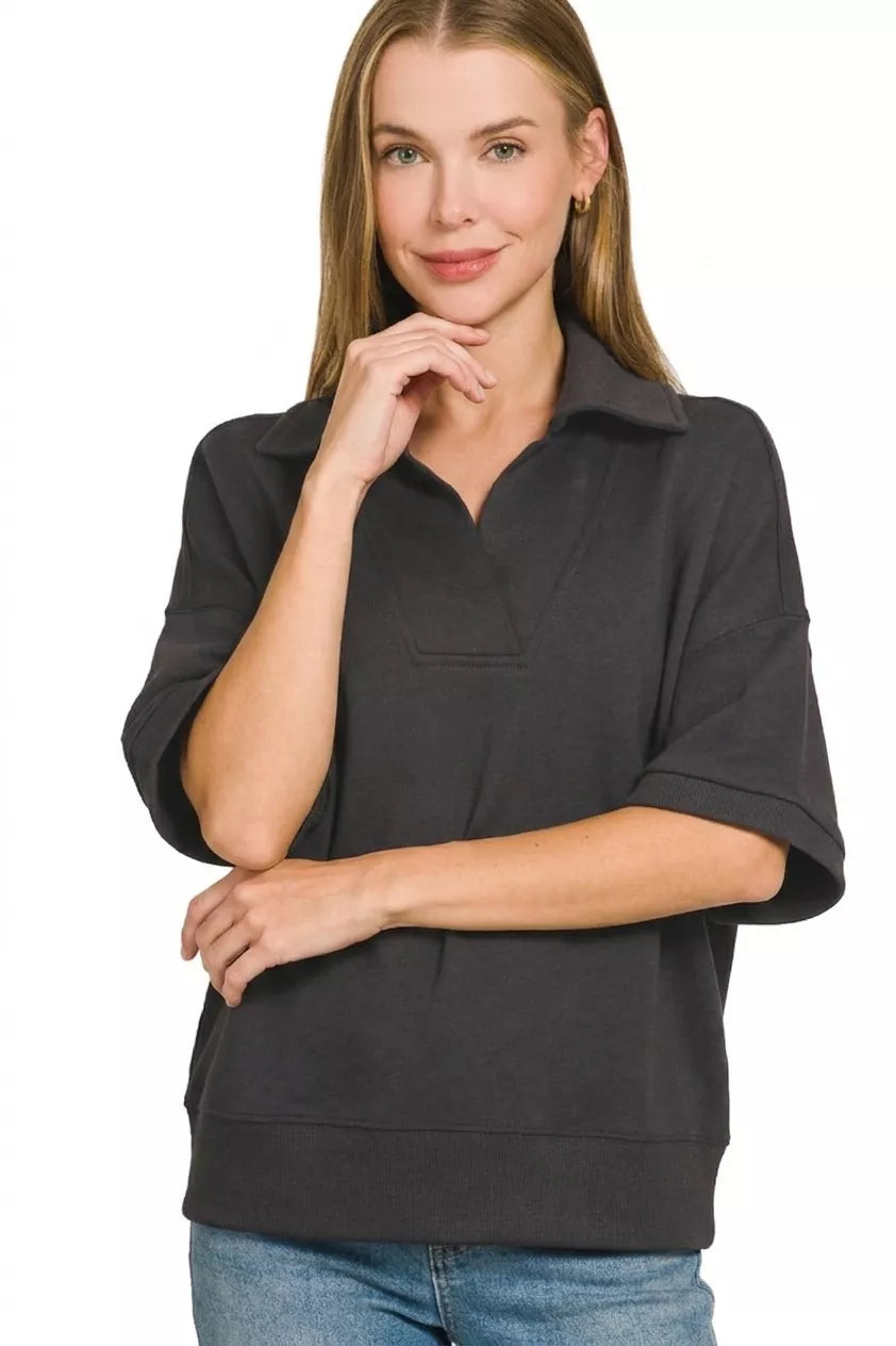 Black Zenana scuba collared short sleeve pullover from Trendsi, featuring a relaxed fit and stylish design.