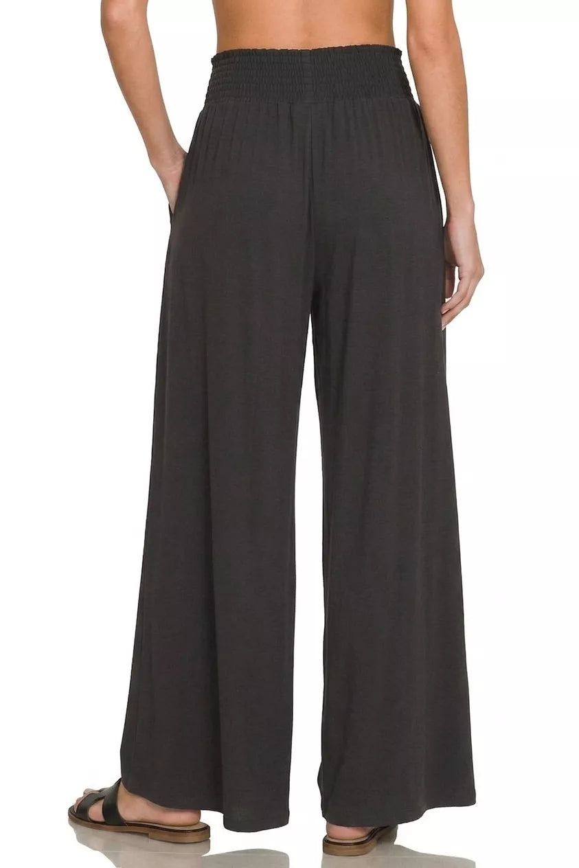 Black Zenana smocked waist wide leg palazzo pants with flowy fabric and relaxed fit, perfect for casual or stylish outfits.