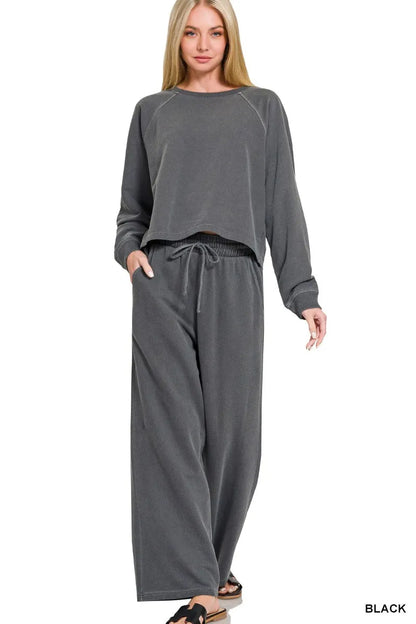 Black Zenana washed fleece round neck pullover and pants set by Trendsi, cozy loungewear with a relaxed fit.