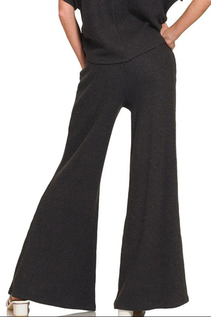 Black Zenana wide-leg flare sweater pants from Trendsi, showing the relaxed fit and soft knit fabric.