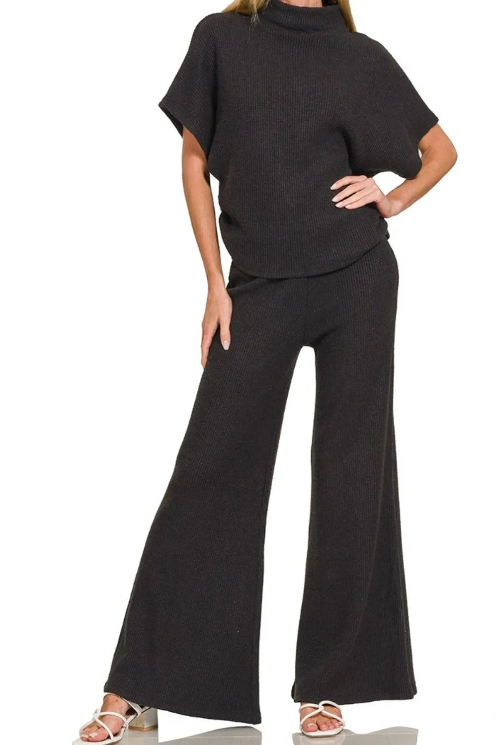 Black Zenana wide leg flare sweater pants with a relaxed fit, styled on a model for comfortable, trendy casual wear.