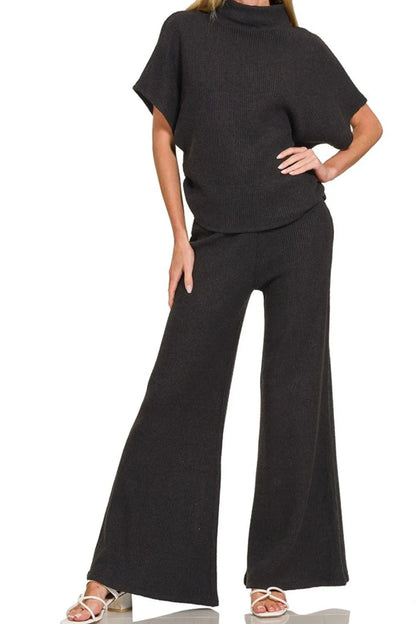 Black Zenana wide leg flare sweater pants with a relaxed fit, styled on a model for comfortable, trendy casual wear.