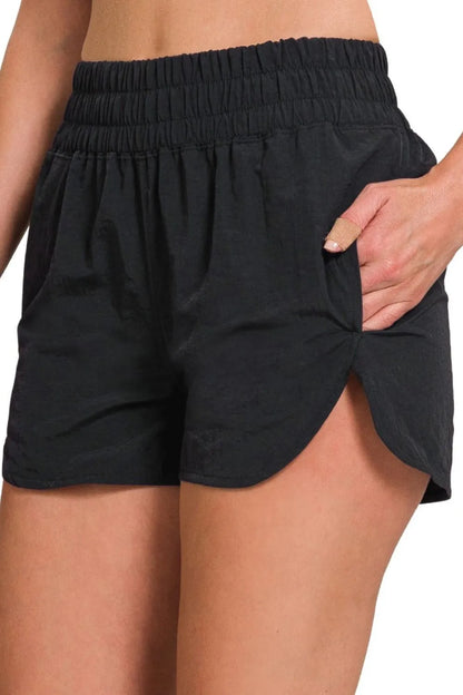 Black Zenana windbreaker running shorts with smocked waistband and relaxed fit, designed for comfortable active wear.