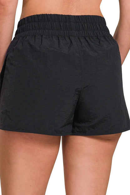 Black Zenana windbreaker running shorts with smocked waistband, lightweight and comfortable for active wear.