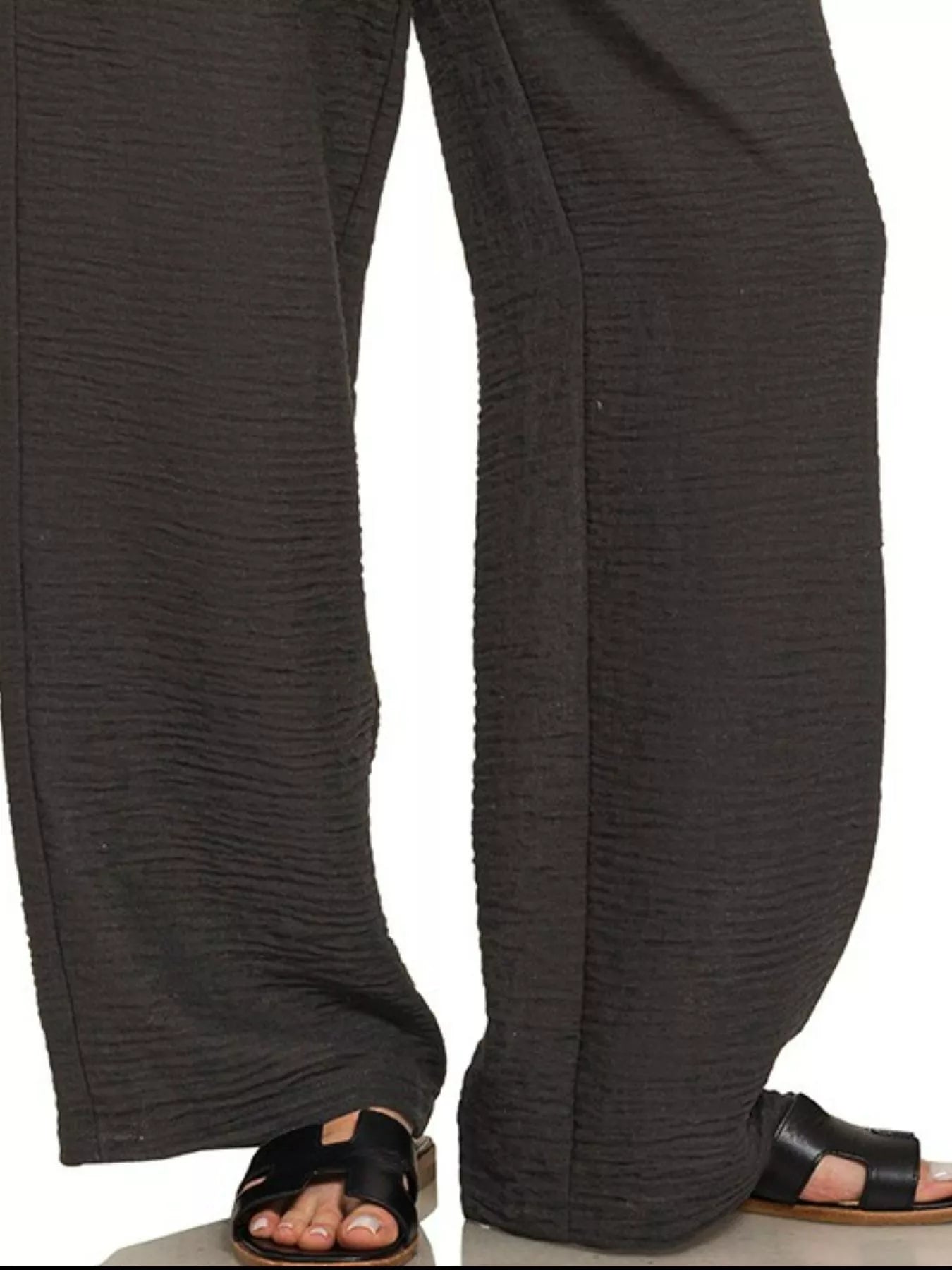 Black Zenana woven crepe pants with elastic waistband, shown on a model, featuring a relaxed fit and stylish design.