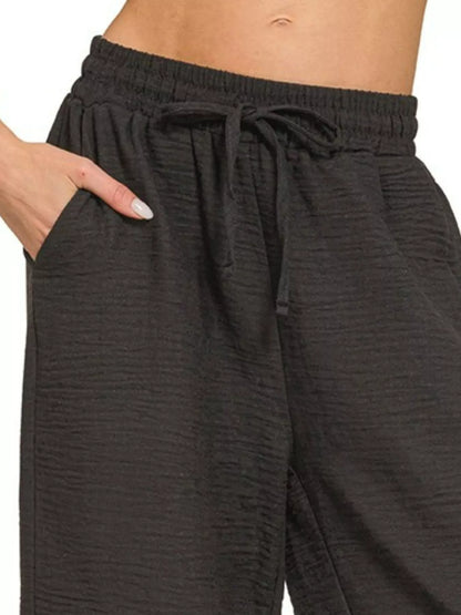 Black Zenana woven crepe pants with elastic waistband, stylish and comfortable women's trousers from Trendsi.