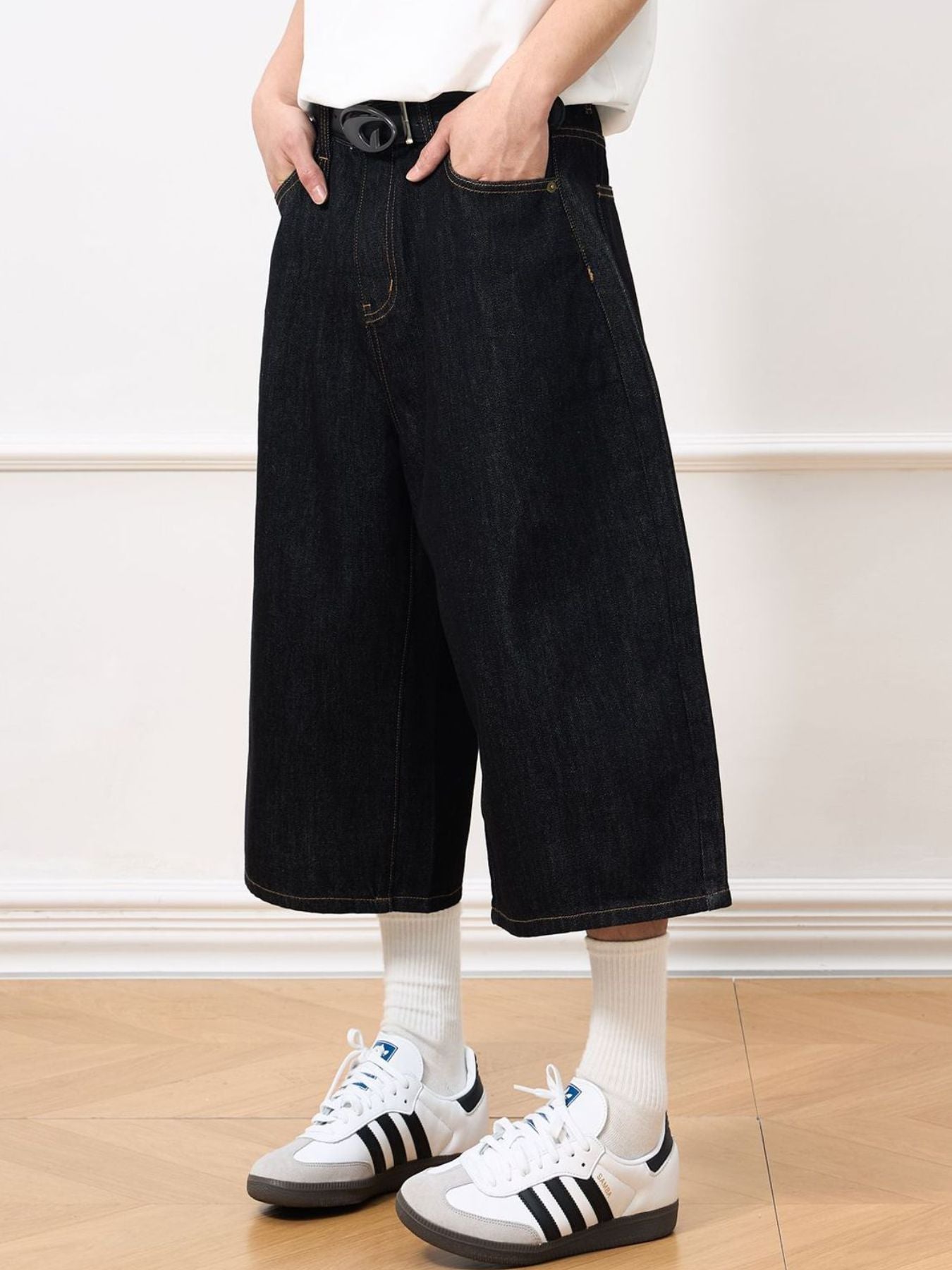 Men's wide leg denim shorts in black from Trendsi, showcasing relaxed fit and casual style on a model.