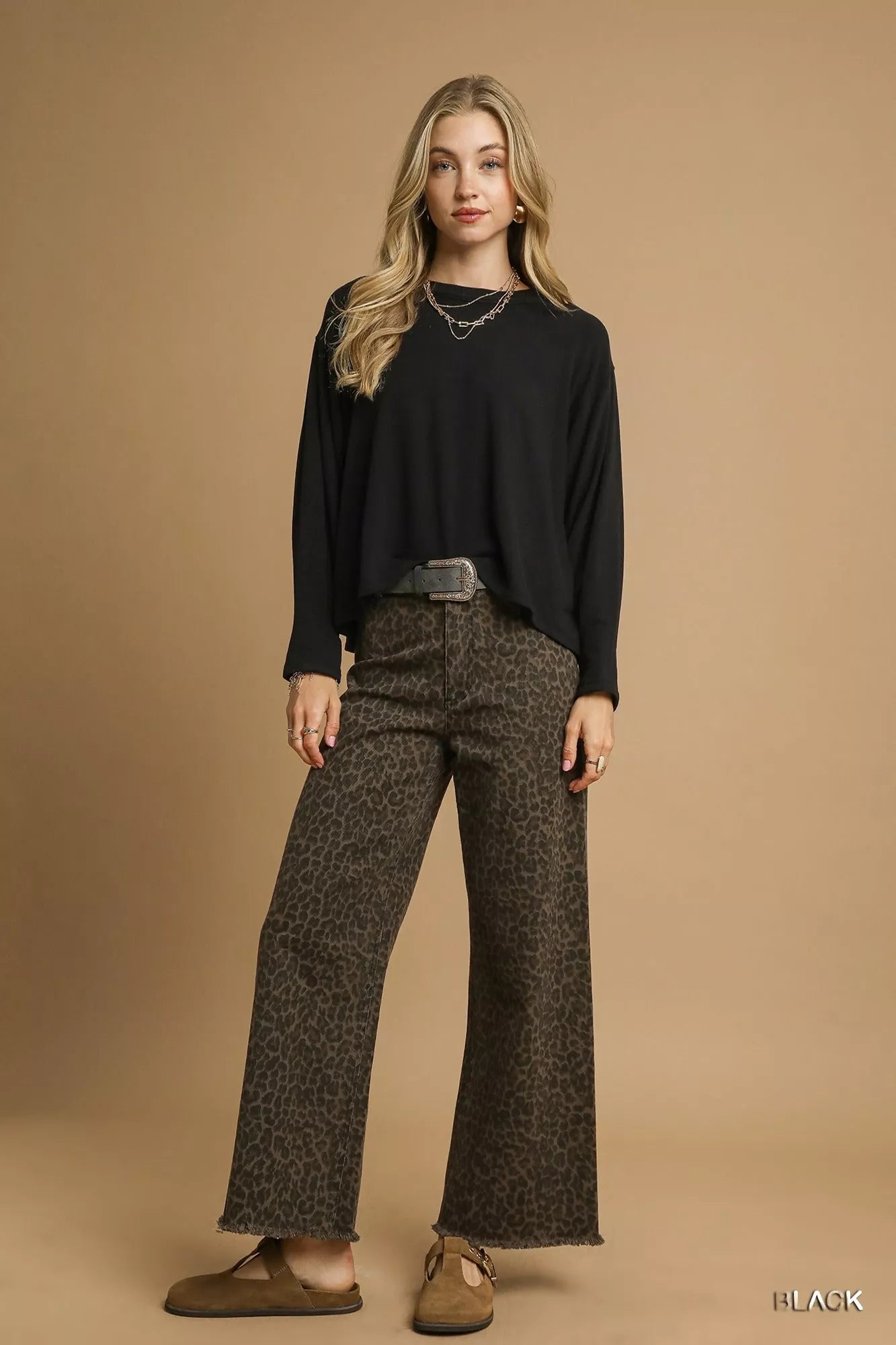 Black Umgee brushed fleece crewneck top with long sleeves, shown on a small size model, cozy and casual for everyday wear.