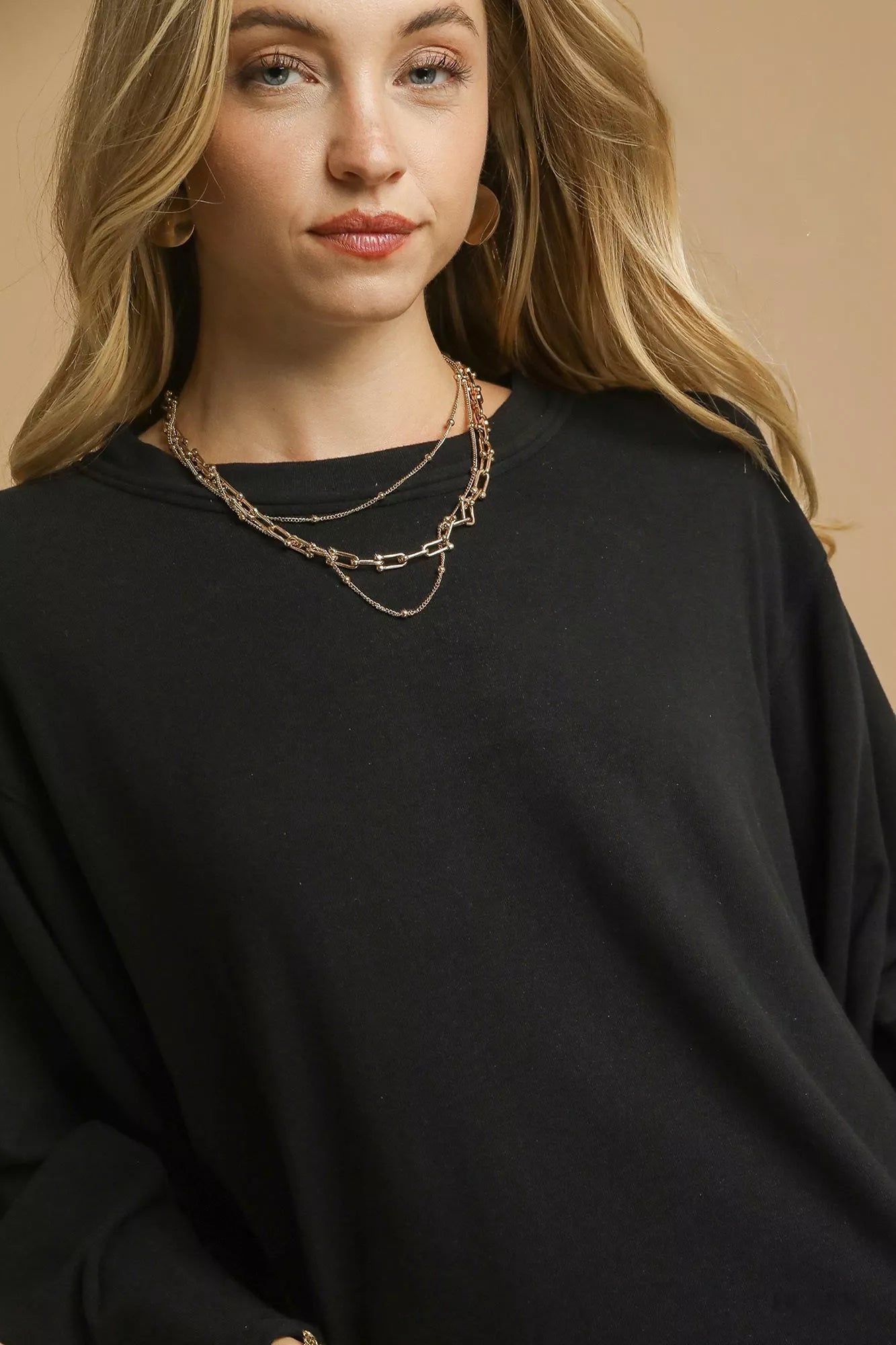 Black Umgee brushed fleece crewneck top featuring long sleeves, casual style, and cozy fabric.