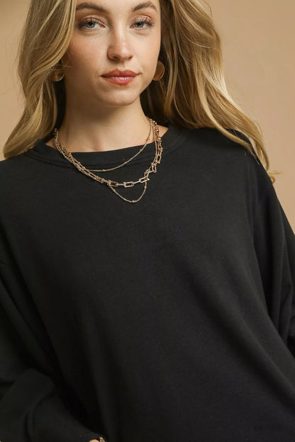 Black Umgee brushed fleece crewneck top featuring long sleeves, casual style, and cozy fabric.