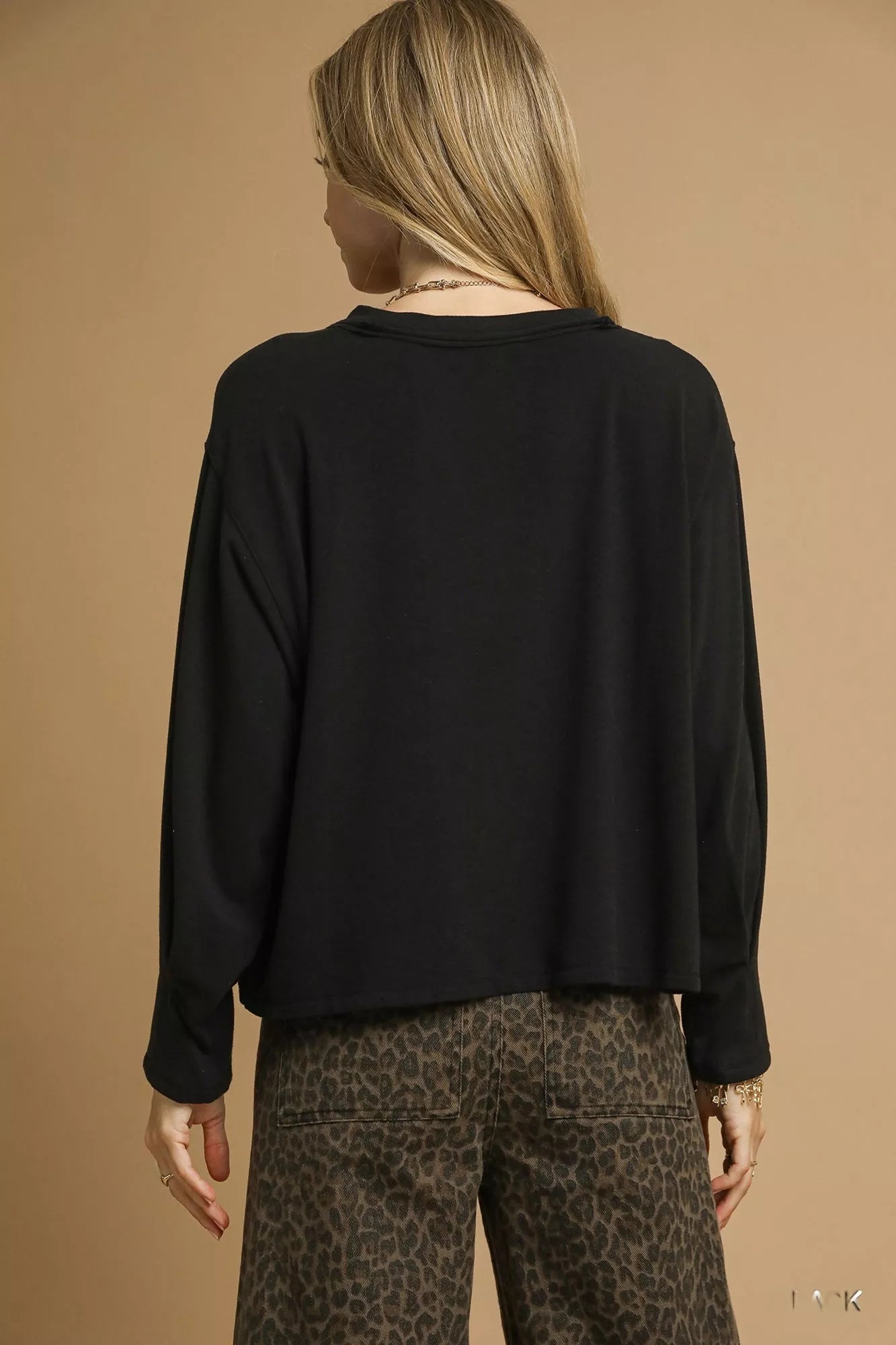 Black Umgee brushed fleece crewneck top with long sleeves, displayed flat on a white background.