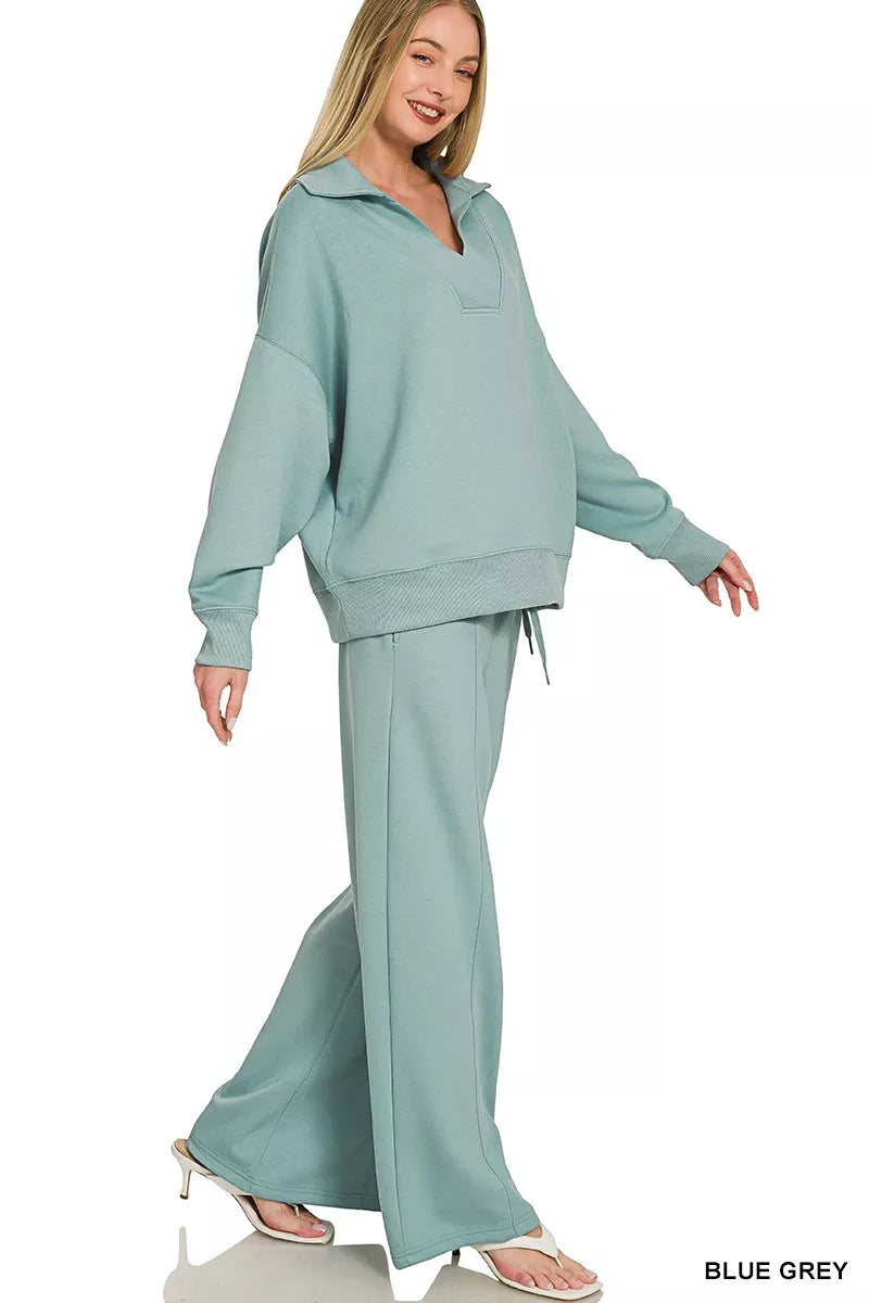 Blue-grey Zenana scuba collared pullover and center seam pants set, casual loungewear by Trendsi, displayed on a flat surface.