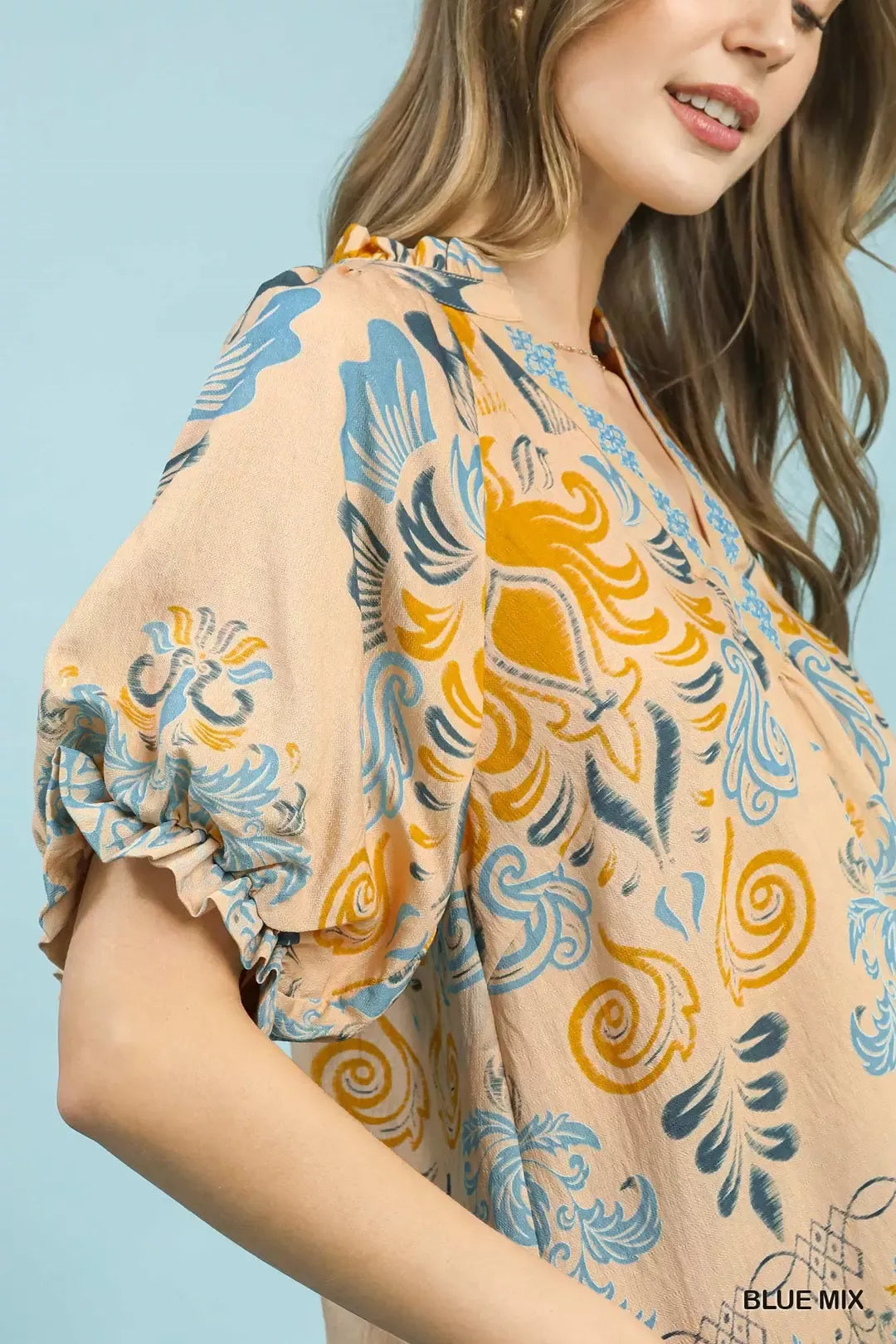 Blue Umgee border print puff sleeve V-neck blouse with relaxed fit and stylish design.