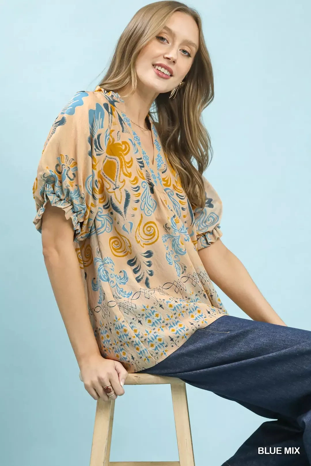Blue mix Umgee border print puff sleeve V-neck blouse, featuring stylish puff sleeves and a flattering V-neck design.