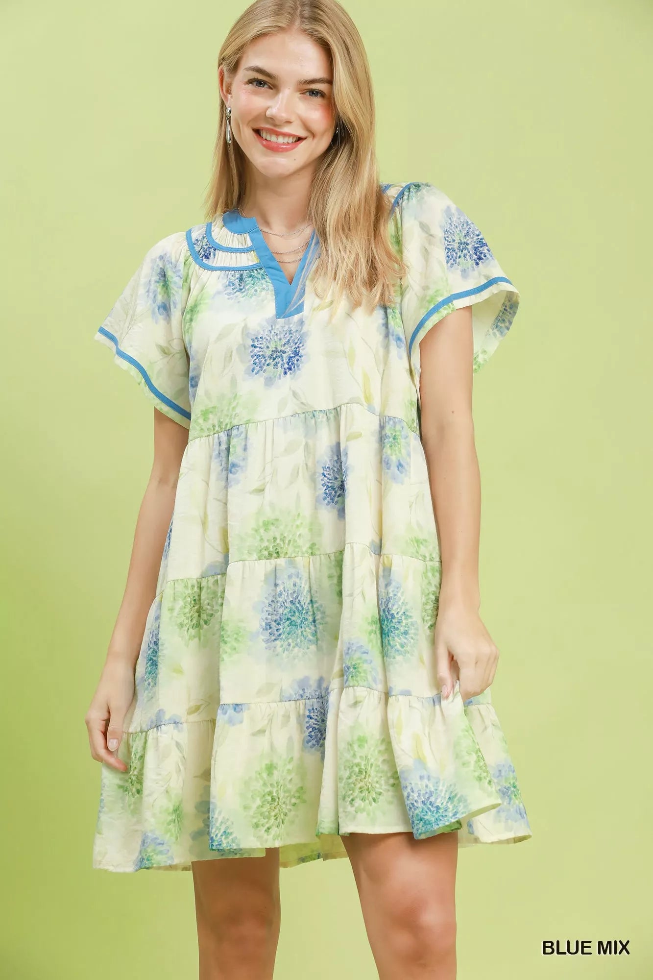 Blue floral print Umgee tiered babydoll dress with contrast trim, featuring a relaxed fit and feminine design.