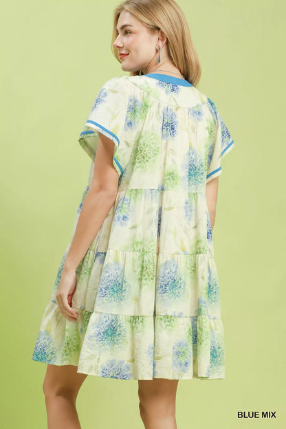 Blue floral print Umgee tiered babydoll dress with contrast trim, featuring a flowy, feminine silhouette and tiered design.