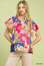 Blue floral patchwork tassel tie top from Umgee, featuring mixed floral prints and tassel details, styled with a relaxed fit.