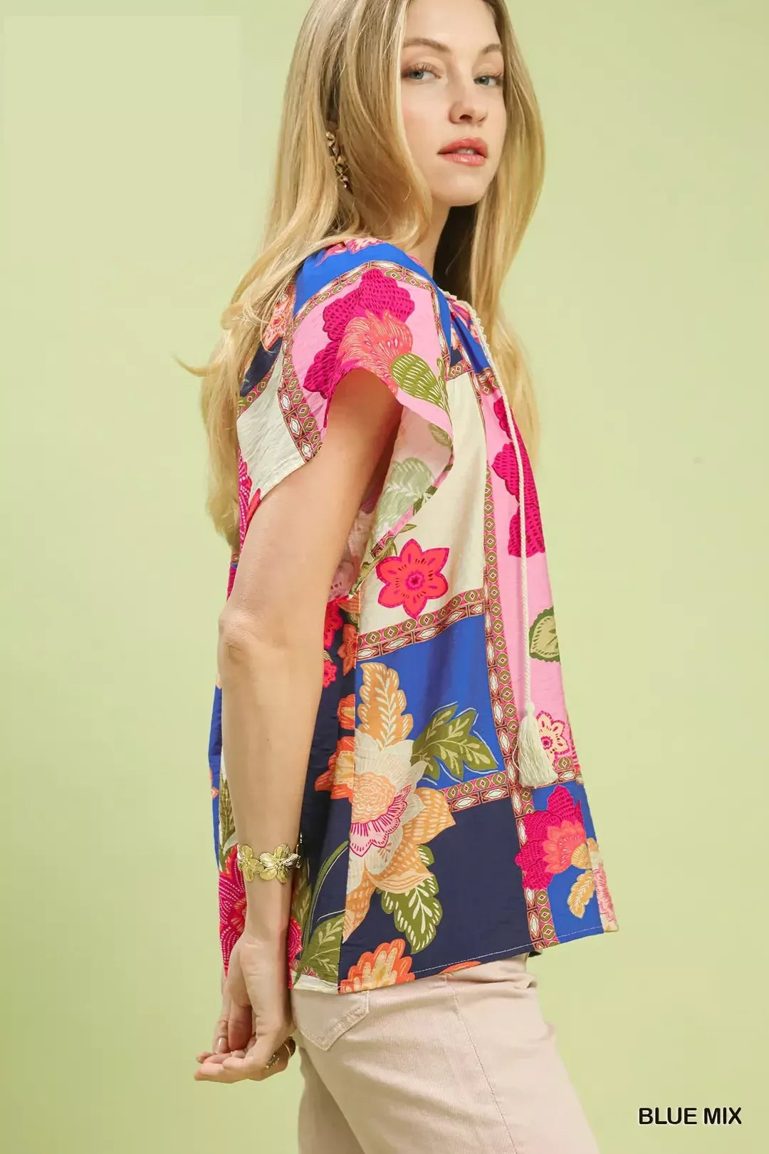 Blue floral patchwork tassel tie top by Umgee featuring mixed patterns and tassel details, perfect for casual and boho styles.
