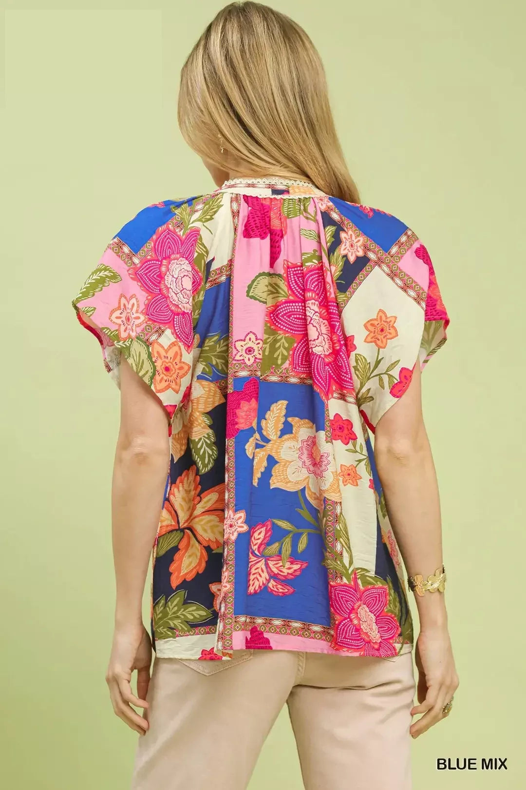 Blue floral patchwork tassel tie top by Umgee featuring mixed patterns and a relaxed fit, styled with tassel details.