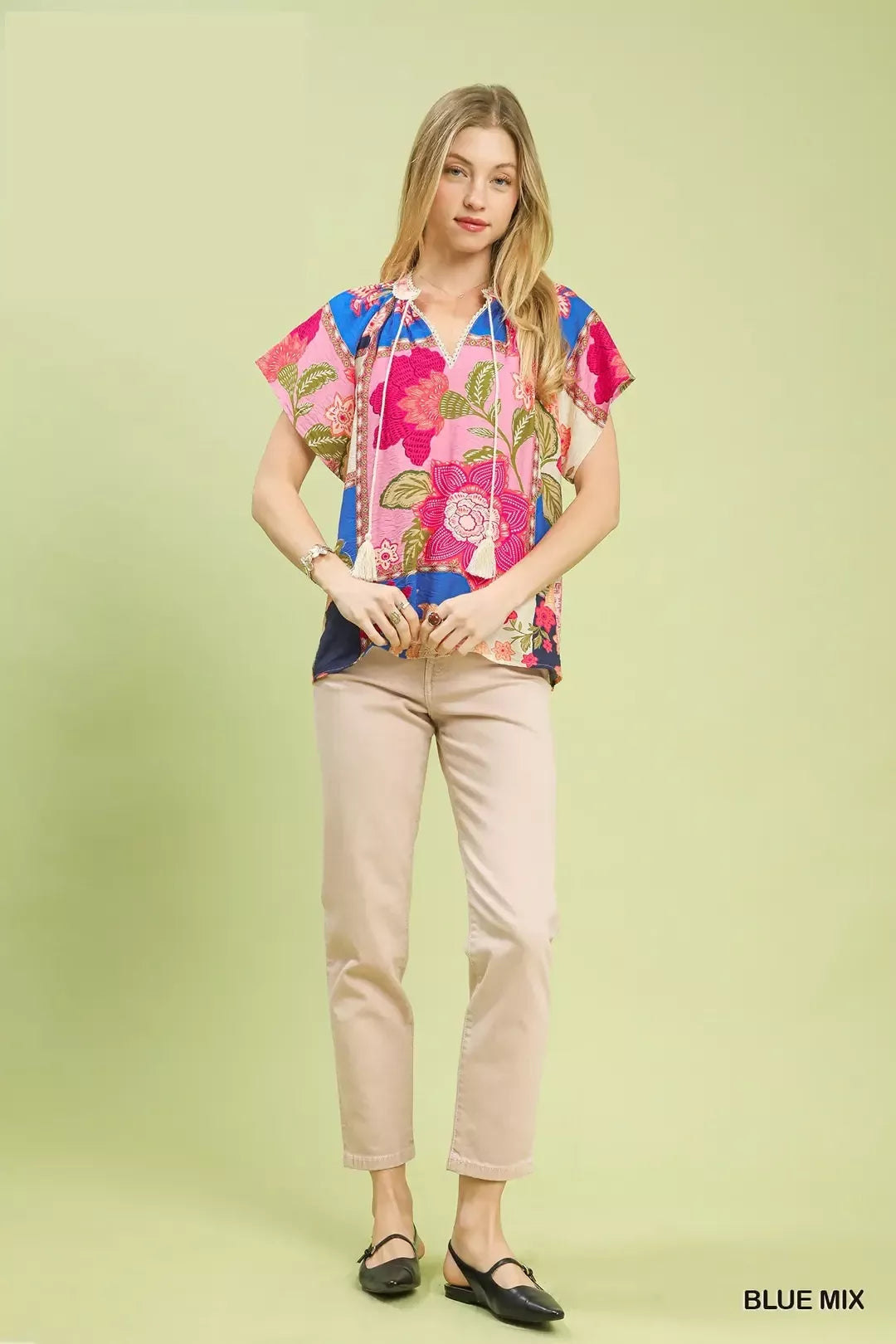 Blue Umgee floral patchwork tassel tie top featuring a relaxed fit, mixed floral patterns, and tassel accents for a boho style.