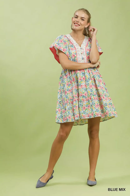 Blue floral tiered mini dress with side pockets by Umgee, featuring a relaxed fit and feminine floral print.
