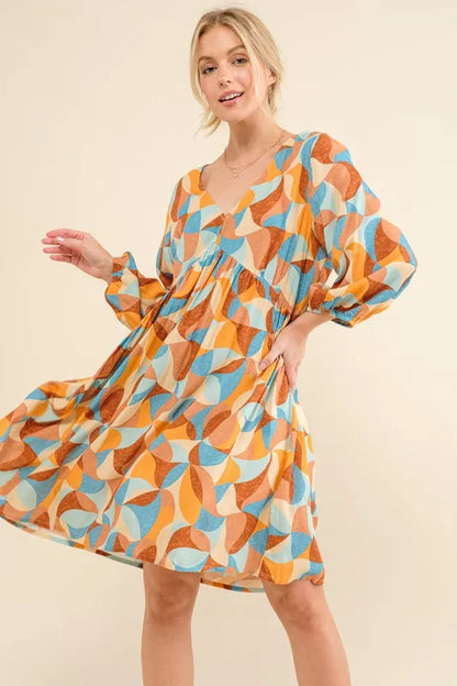 Blue multi-color printed open-back casual dress with puff sleeves by Trendsi, featuring a relaxed fit and stylish design.