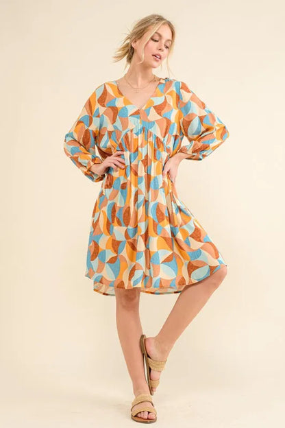 Blue multi-colored open-back casual dress with puff sleeves by Trendsi, featuring a printed design and relaxed fit.