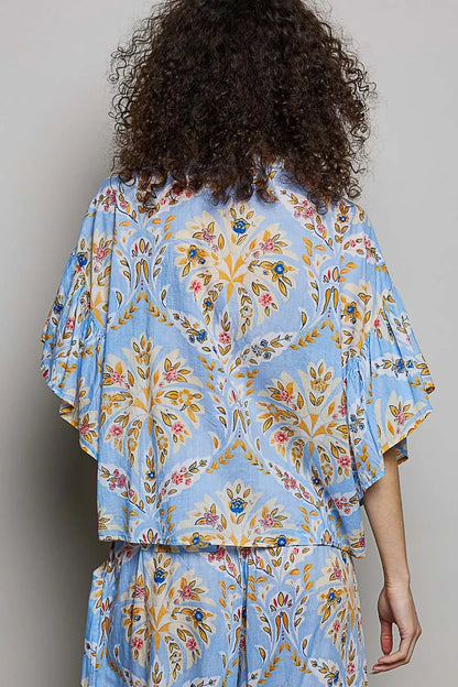 Blue floral printed woven ruffle sleeve shirt by Trendsi, featuring vibrant floral design and stylish ruffle sleeves.