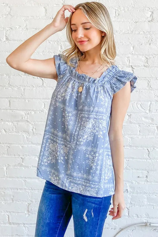 Blue boho print ruffle baby doll tank top from And The Why by Trendsi, featuring a relaxed fit and feminine ruffle details.