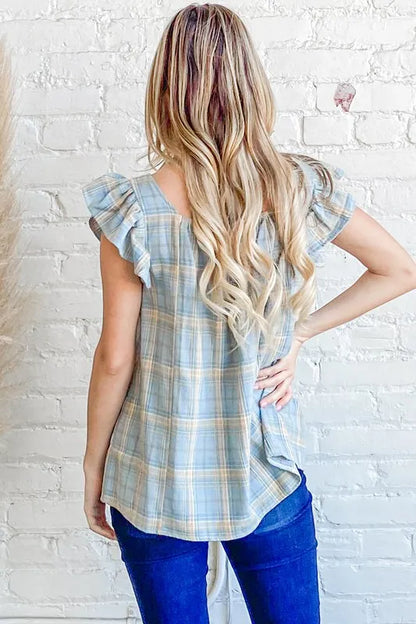 Blue plaid print baby doll top by Trendsi with smocked details and ruffle accents, perfect for casual or dressy wear.