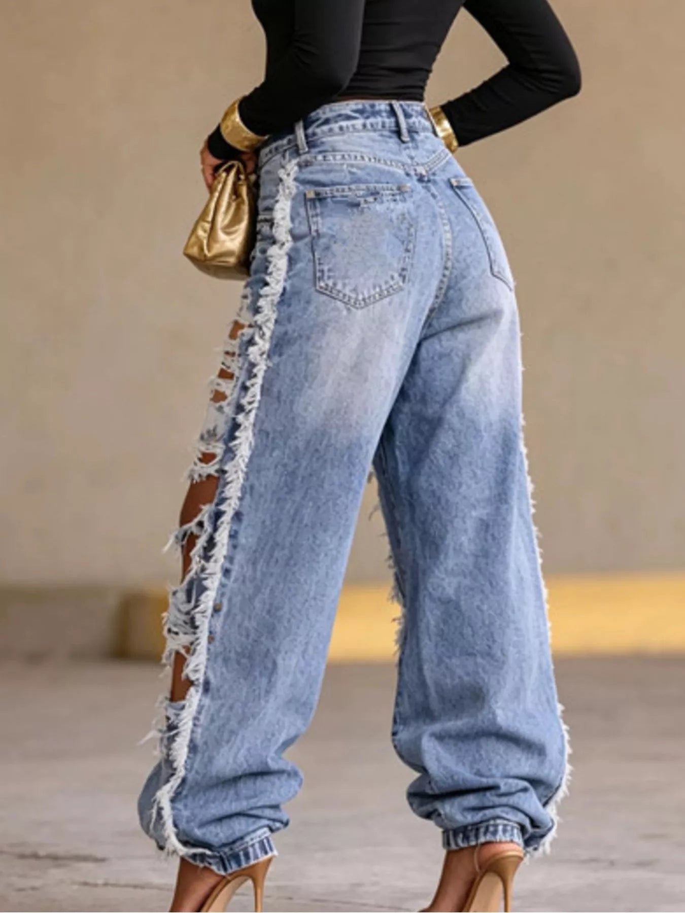 Blue distressed loose fit jeans by Trendsi, showing relaxed fit and ripped details in a casual style.