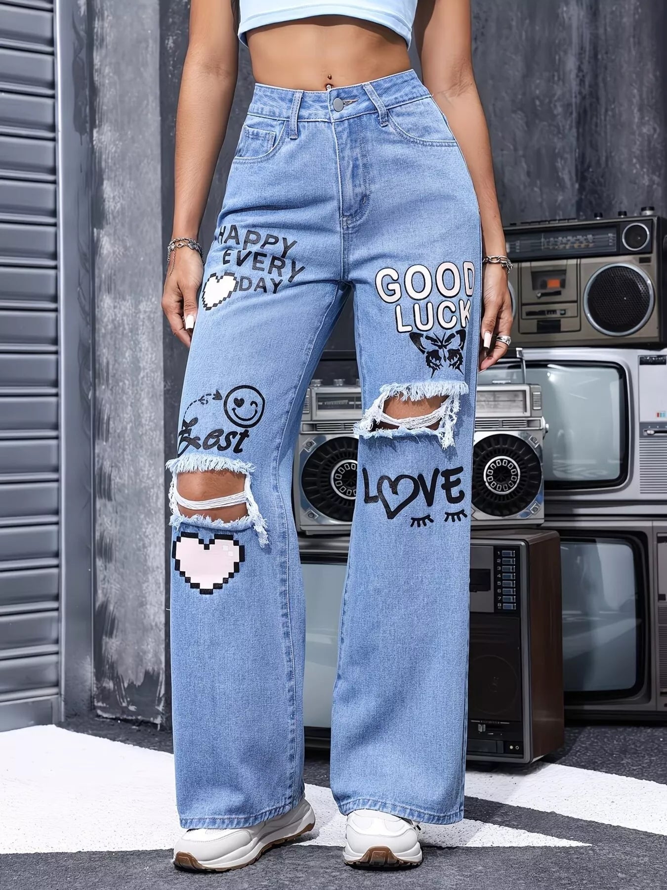 Blue distressed printed wide-leg jeans from Trendsi featuring a relaxed fit and stylish faded details.