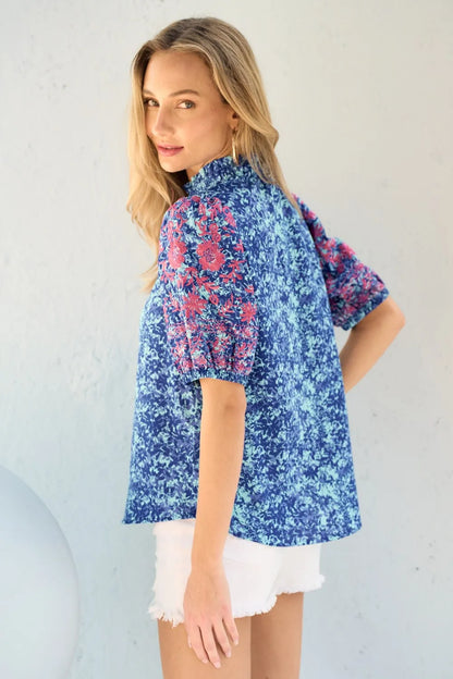 Blue embroidered puff sleeve blouse from Hailey & Co by Trendsi, featuring printed fabric and stylish, feminine design.
